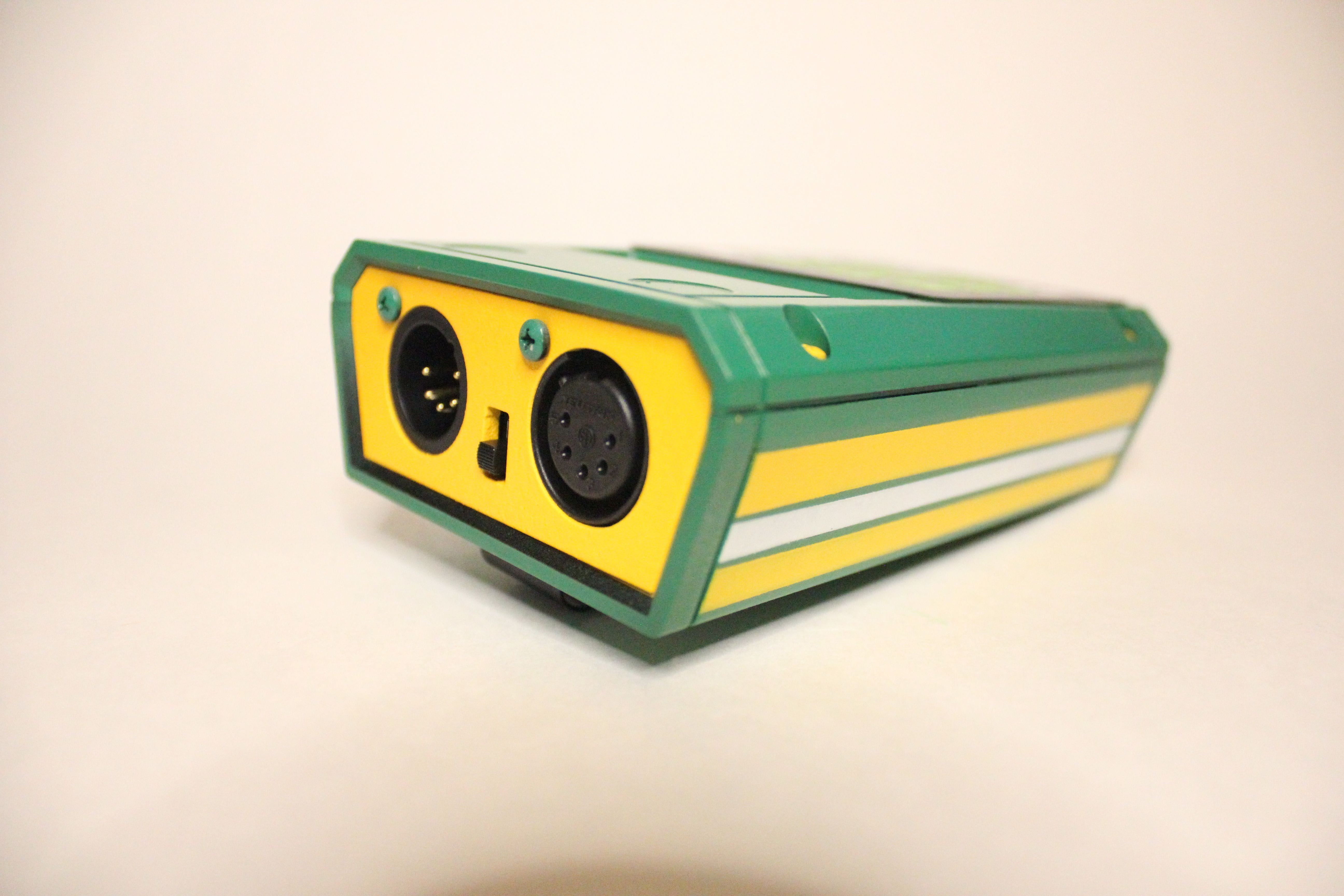 A custom painted DXT1 DMX Tester. For an additional fee, we can custom paint your DXT1 DMX Tester. Green with yellow stripes.